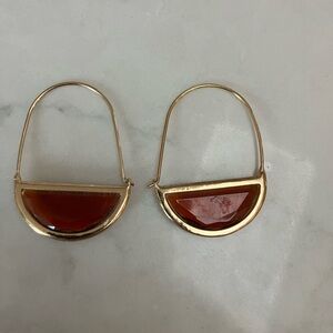 Gold toned earrings with rust colored faux stone